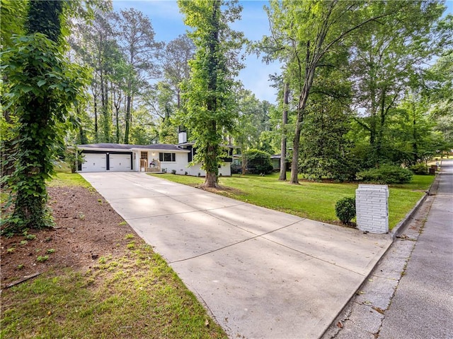 466 Thackery Pl SW, Atlanta, GA 30311 - view of front of house with concrete driveway, an attached garage, and a front yard
