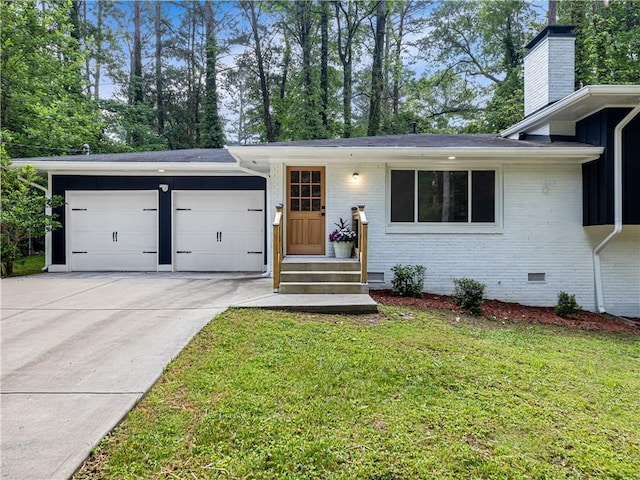 466 Thackery Pl SW, Atlanta, GA 30311 - view of front of home featuring a garage, driveway, a chimney, a front yard, and brick siding
