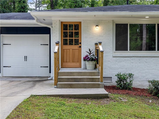 466 Thackery Pl SW, Atlanta, GA 30311 - property entrance with driveway, brick siding, a shingled roof, and an attached garage