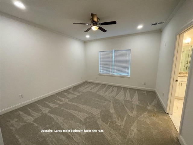 unfurnished room featuring carpet flooring, ornamental molding, and ceiling fan