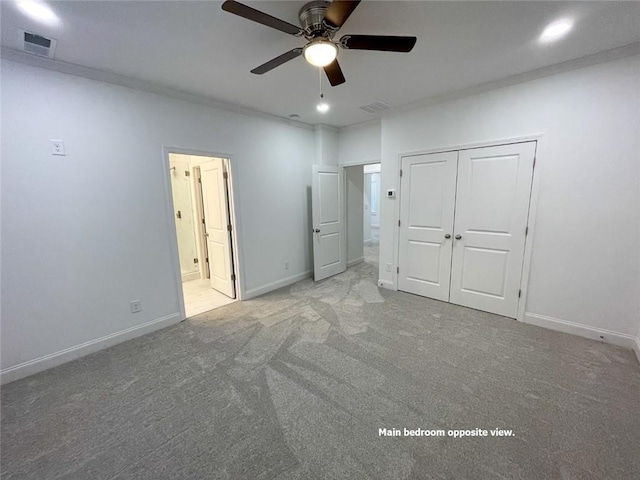 unfurnished bedroom with ceiling fan, a closet, and light carpet