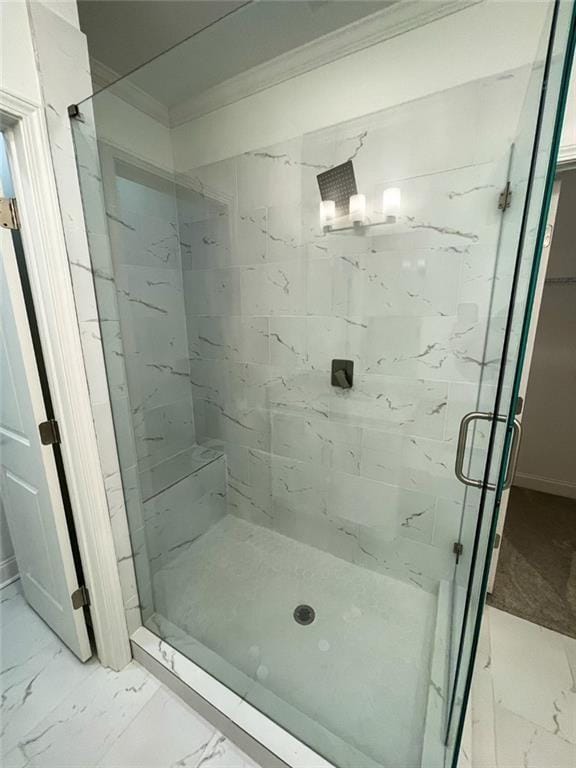 bathroom featuring ornamental molding and walk in shower