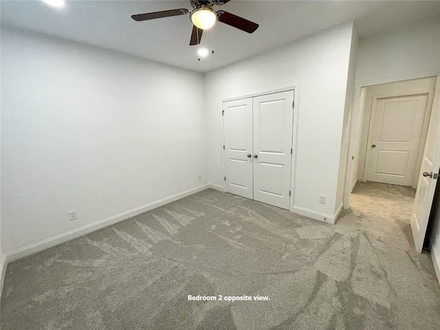 unfurnished bedroom featuring a closet, ceiling fan, and light carpet