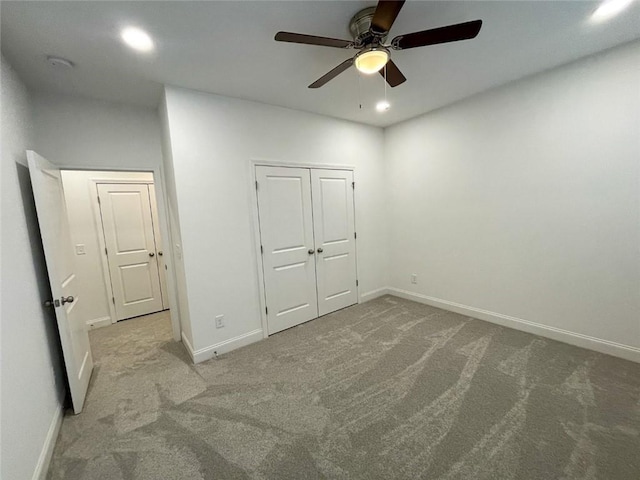 unfurnished bedroom with a closet, light carpet, and ceiling fan