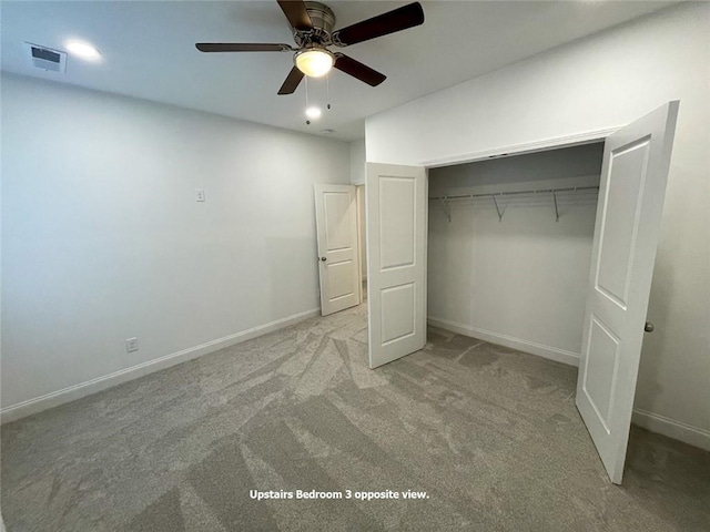 unfurnished bedroom featuring a closet, ceiling fan, and light colored carpet