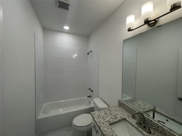 full bathroom featuring tiled shower / bath, vanity, and toilet