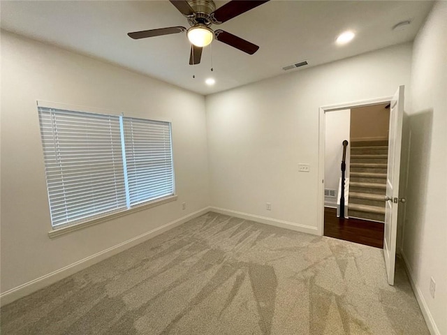 carpeted empty room with ceiling fan