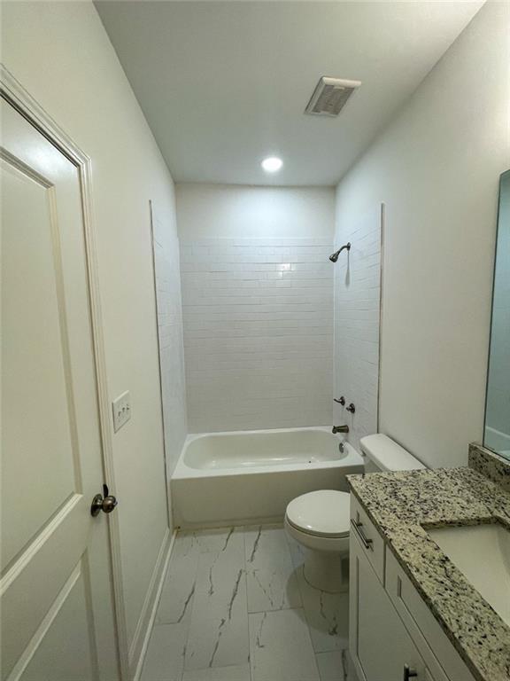 full bathroom featuring bathtub / shower combination, vanity, and toilet