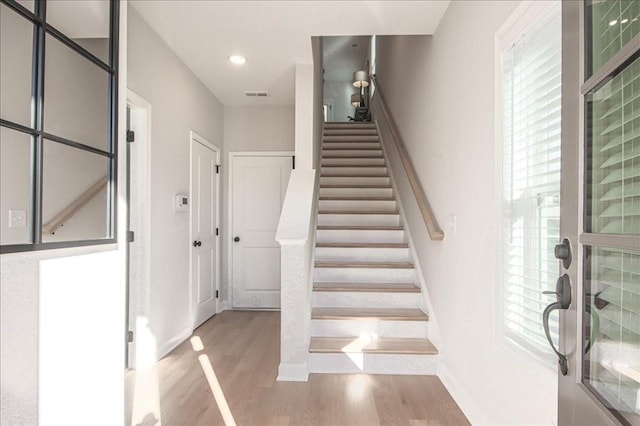 stairs featuring visible vents, recessed lighting, baseboards, and wood finished floors