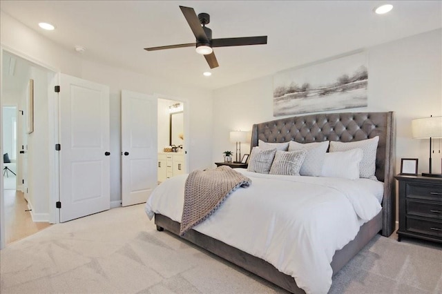carpeted bedroom featuring recessed lighting, ceiling fan, and ensuite bath