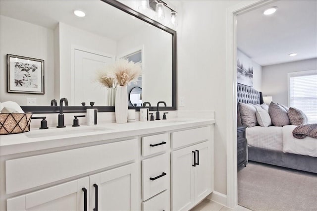 ensuite bathroom with a sink, recessed lighting, ensuite bath, and double vanity
