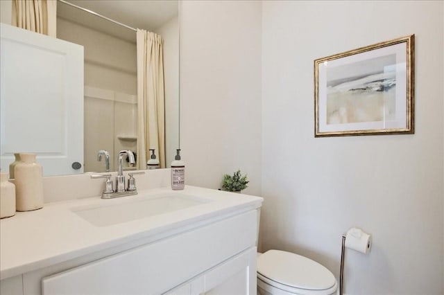 bathroom featuring vanity, a shower with shower curtain, and toilet