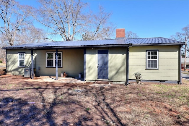 rear view of property featuring a patio and central AC