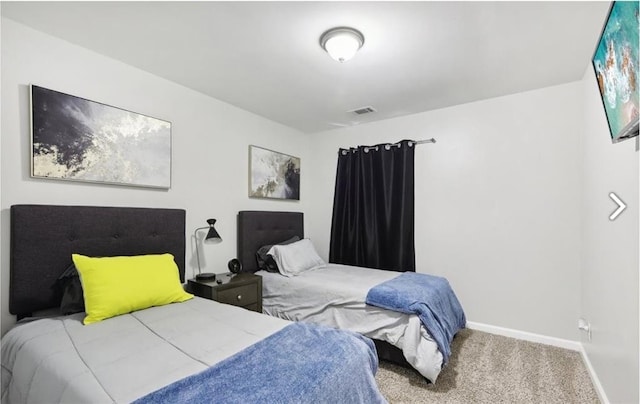 carpeted bedroom featuring visible vents and baseboards
