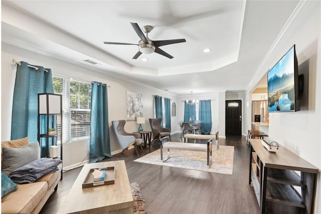living area with recessed lighting, ceiling fan, a raised ceiling, baseboards, and wood finished floors