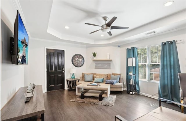 living area with a raised ceiling, visible vents, dark wood-style floors, recessed lighting, and a ceiling fan