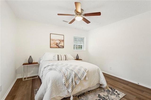 bedroom with baseboards, visible vents, ceiling fan, and wood finished floors