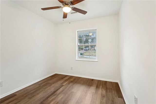 unfurnished room with wood finished floors, a ceiling fan, and baseboards