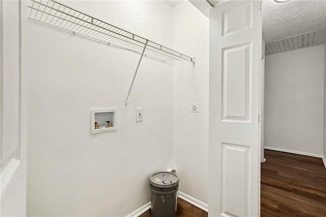 washroom featuring laundry area, baseboards, dark wood-style flooring, hookup for a washing machine, and a textured ceiling