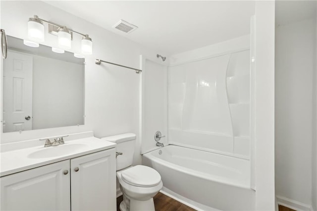 full bathroom with shower / tub combination, toilet, wood finished floors, visible vents, and vanity