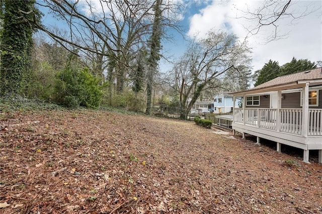 view of yard with fence and a wooden deck