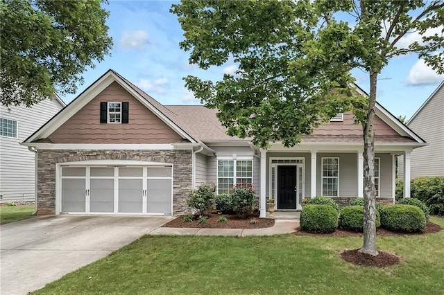 craftsman-style home featuring a front yard and a garage