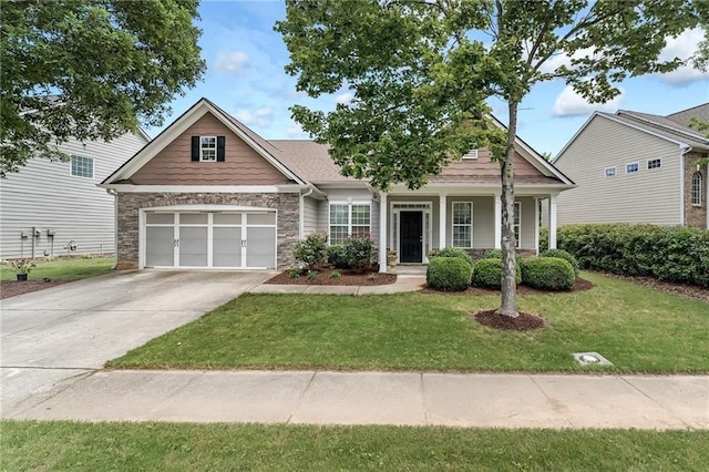 view of front facade with a porch, a garage, and a front yard