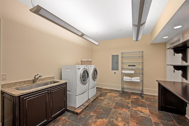 laundry area with washer and clothes dryer, stone tile flooring, electric panel, cabinet space, and baseboards