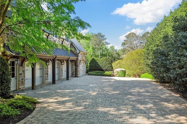 view of home's community featuring decorative driveway