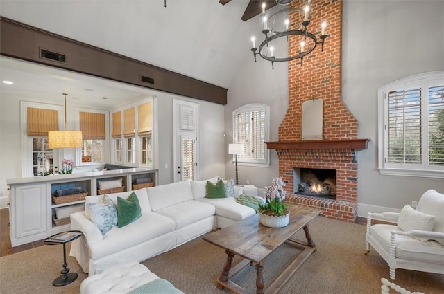 living area featuring high vaulted ceiling, a chandelier, wood finished floors, a fireplace, and baseboards