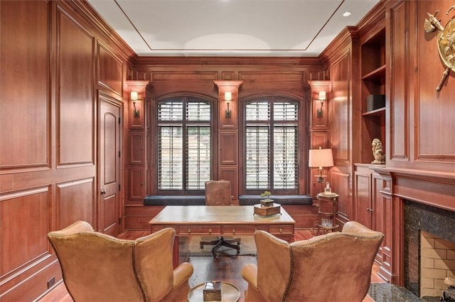 office area featuring a premium fireplace and a decorative wall
