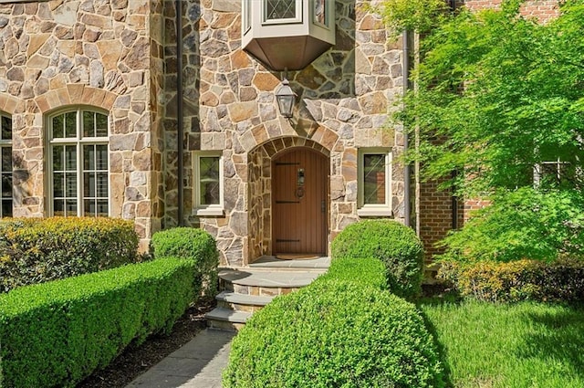 property entrance with stone siding