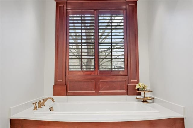 full bathroom featuring healthy amount of natural light and a garden tub