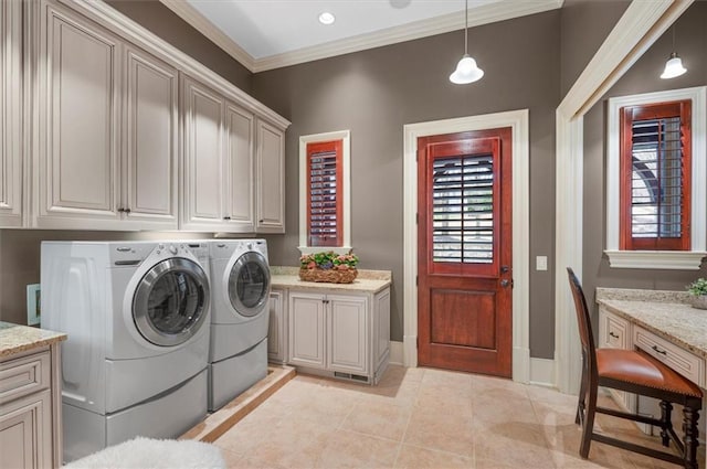 laundry room featuring cabinet space, washer and dryer, light tile patterned flooring, ornamental molding, and baseboards