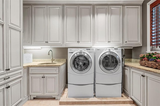 laundry room with cabinet space and separate washer and dryer