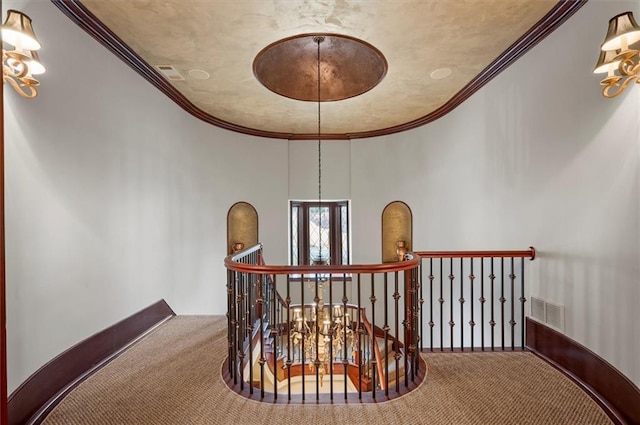 stairs with carpet flooring and ornamental molding