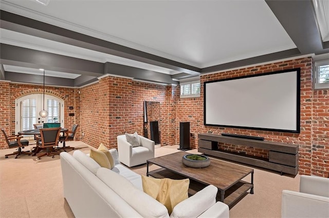 carpeted home theater room with ornamental molding, brick wall, and arched walkways
