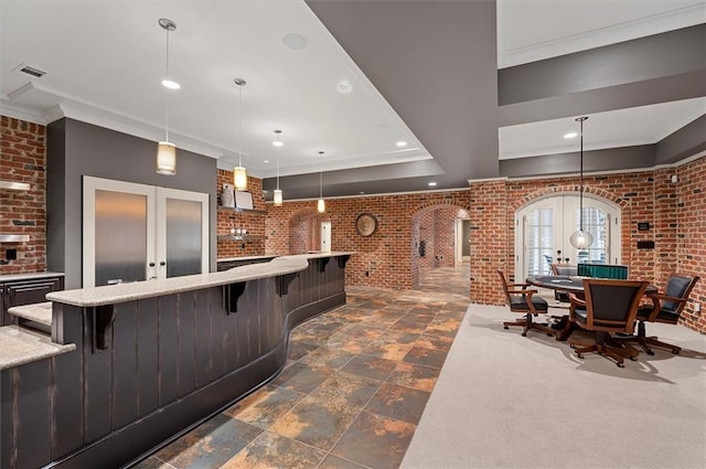 welcome area with french doors, brick wall, crown molding, recessed lighting, and arched walkways