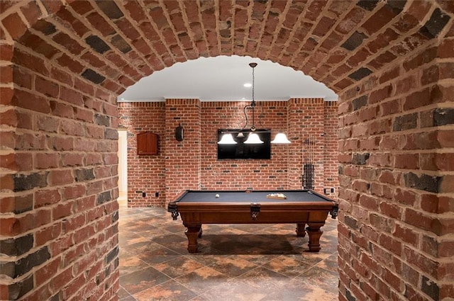 recreation room featuring brick wall and billiards table