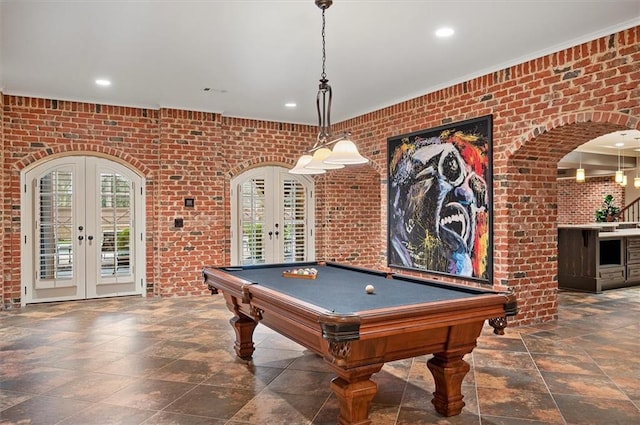 game room with french doors, brick wall, billiards table, recessed lighting, and stone tile floors