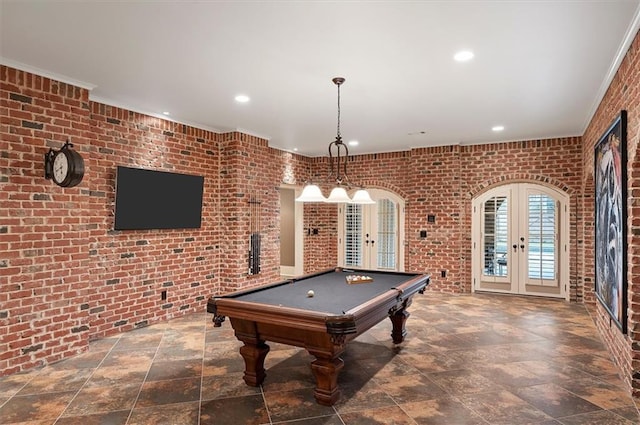 playroom featuring french doors, brick wall, recessed lighting, billiards table, and stone finish flooring