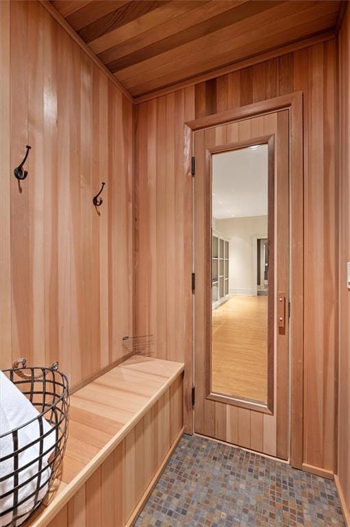 mudroom featuring wood walls and wooden ceiling