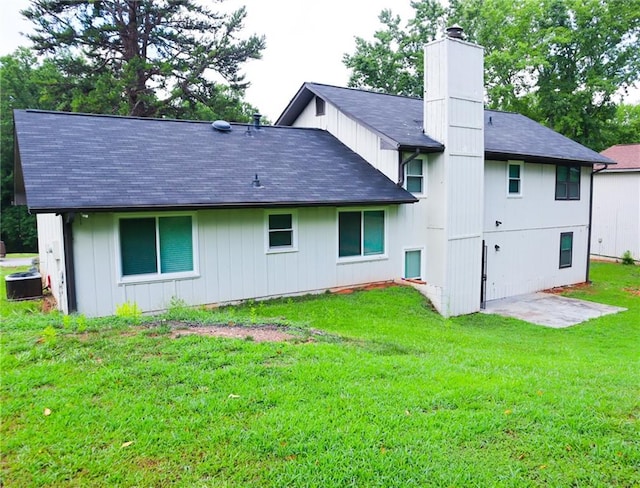 rear view of house with a yard