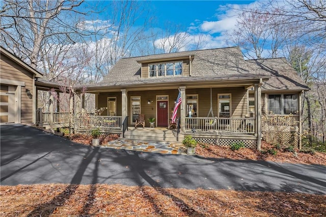 bungalow featuring a garage and covered porch