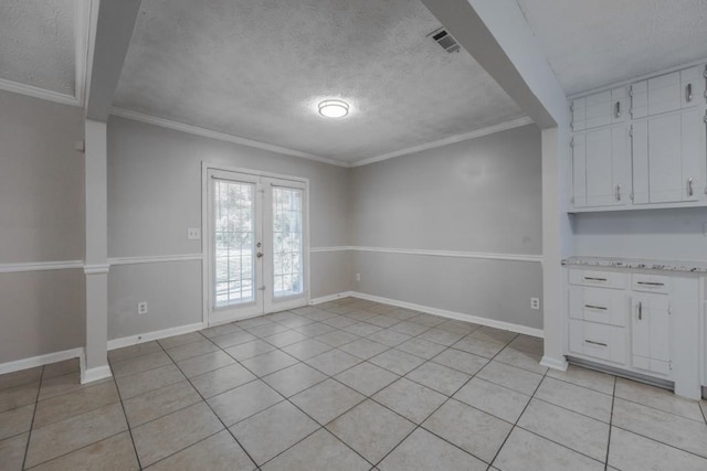 2173 Martin Way, Jonesboro, GA 30236 - unfurnished dining area featuring light tile patterned floors, a textured ceiling, french doors, baseboards, and ornamental molding