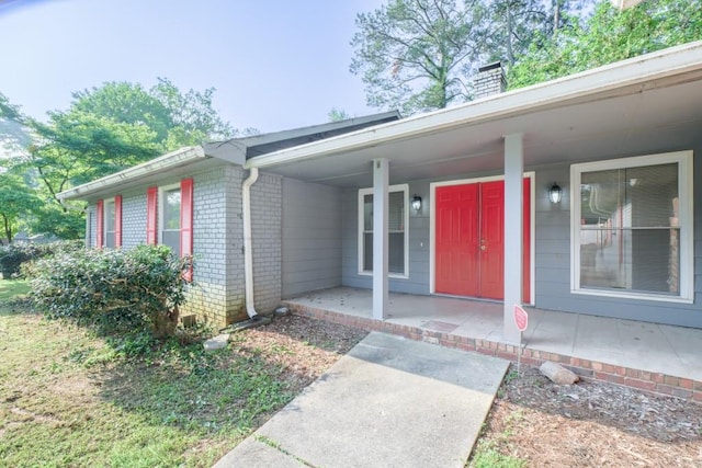 2173 Martin Way, Jonesboro, GA 30236 - property entrance with brick siding, a chimney, and covered porch