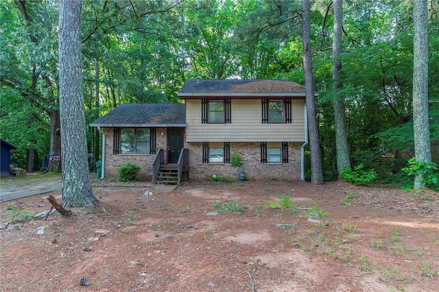 4342 Lincolndale Dr, Ellenwood, GA 30294 - tri-level home featuring brick siding and view of scattered trees