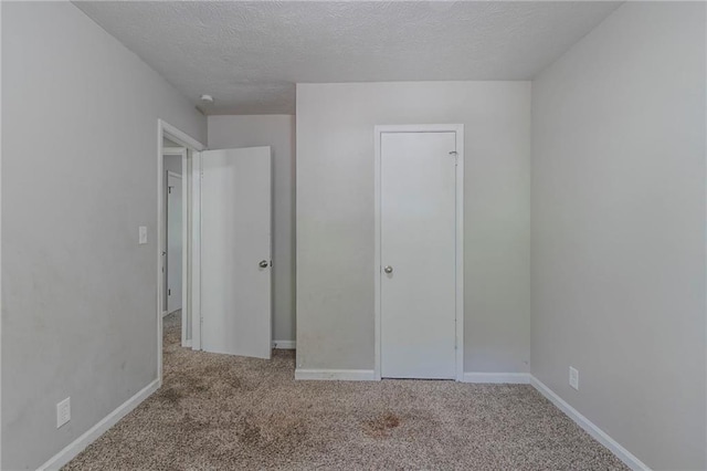 4342 Lincolndale Dr, Ellenwood, GA 30294 - unfurnished bedroom featuring carpet flooring, a textured ceiling, and baseboards