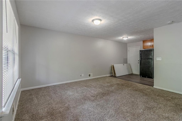 4342 Lincolndale Dr, Ellenwood, GA 30294 - empty room with carpet, baseboards, and a textured ceiling