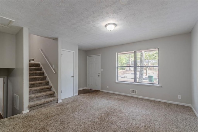 4342 Lincolndale Dr, Ellenwood, GA 30294 - unfurnished living room featuring carpet flooring, baseboards, stairs, and a textured ceiling